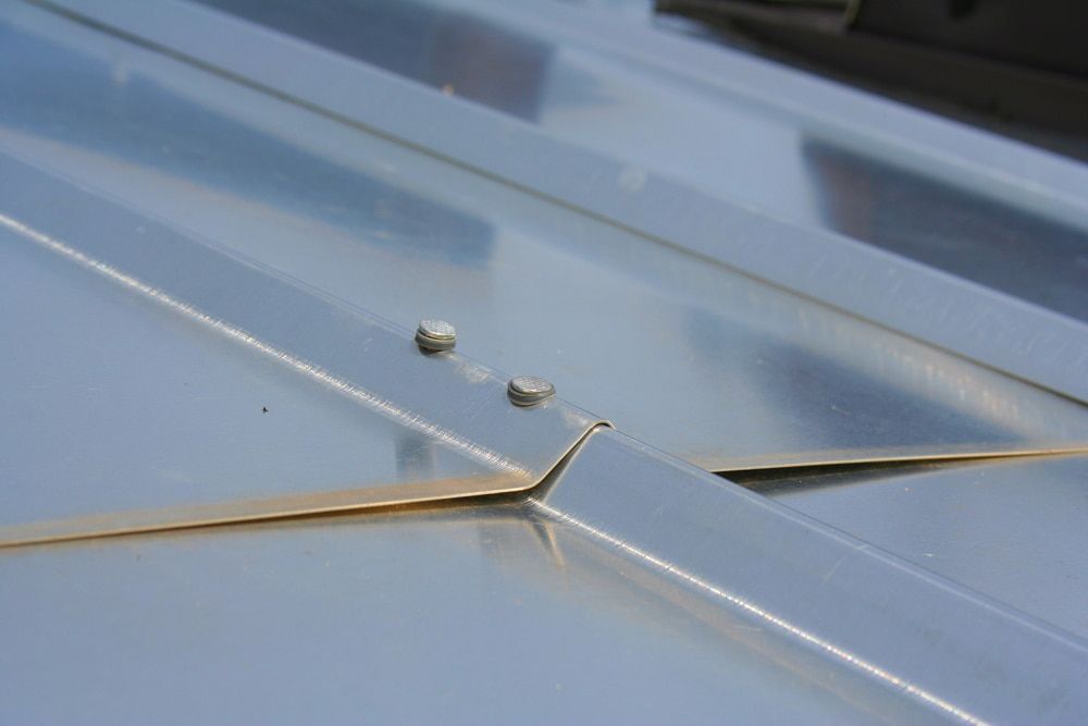 A Close up Of a Metal Roof with Screws on It — Rooftech Roofing Services in Ballina, NSW