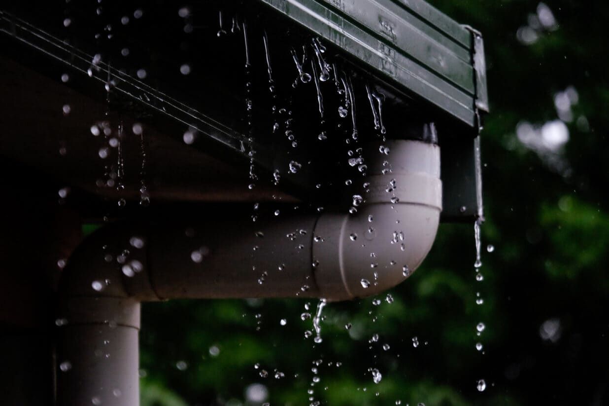Rain Is Falling from The Gutter of A House — Rooftech Roofing Services in Ballina, NSW