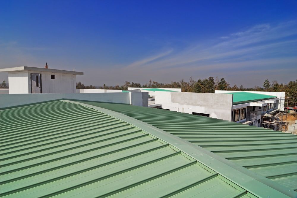 A Green Roof of A Building with A Blue Sky in The Background — Rooftech Roofing Services in Ballina, NSW