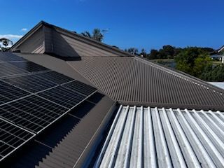 A Grey Roof with A Window on Top of It — Rooftech Roofing Services in Byron Bay, NSW