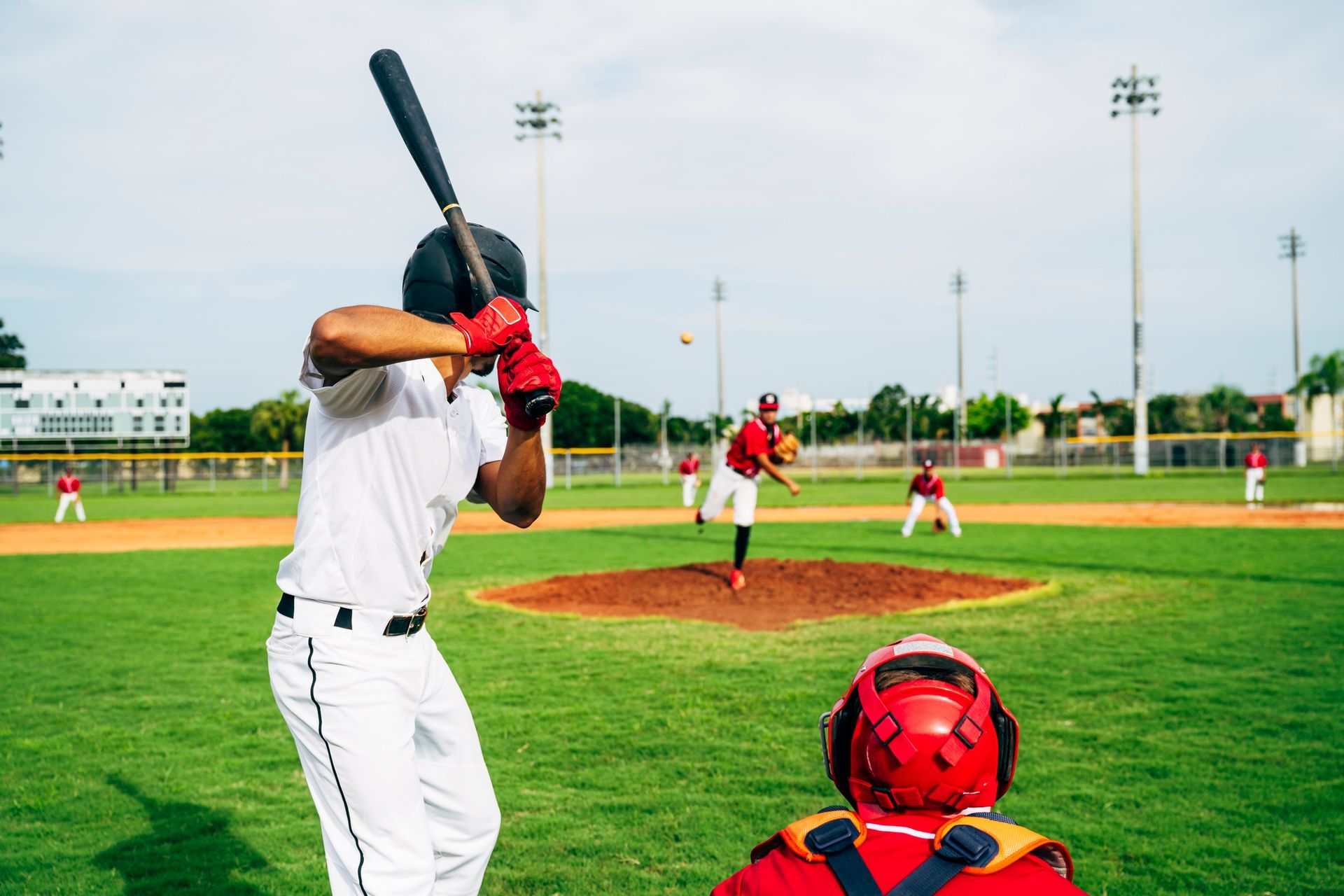 People playing baseball in a field.