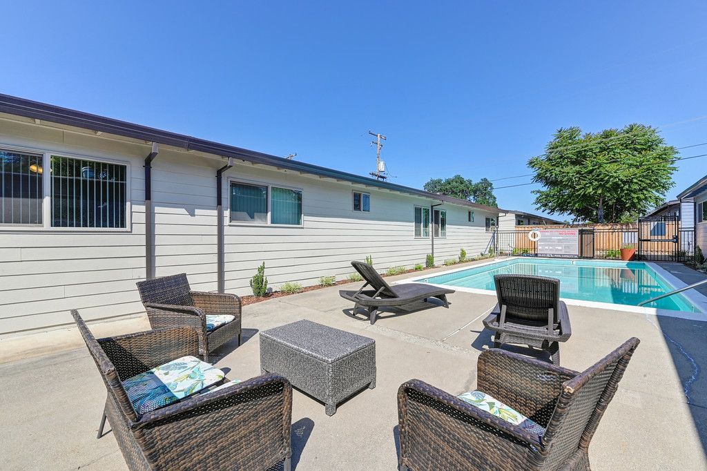 Back Side  Swimming Pool with four chairs