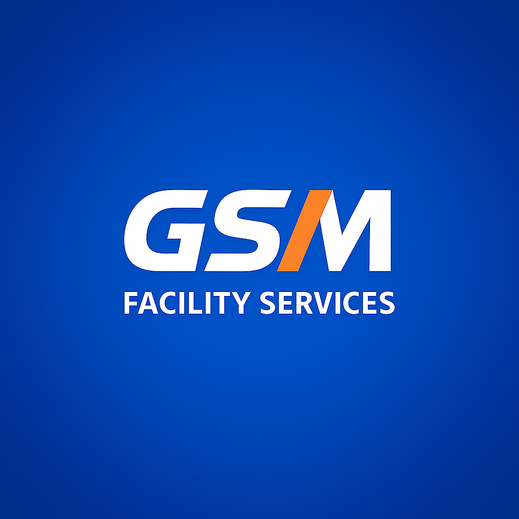 Logo for GSM Facility Services, white text with an orange slash between the S and M.