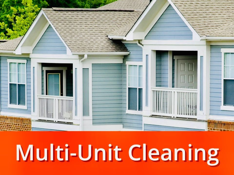 Blue multi-unit building with white trim and orange text 