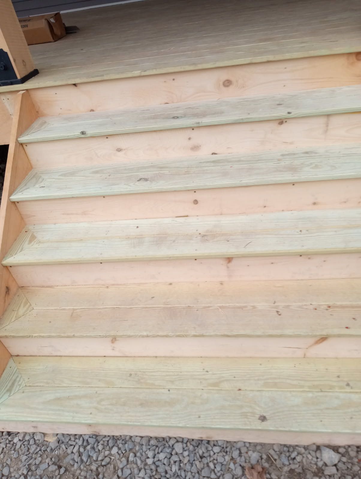 Wooden outdoor stairs leading up to a porch.