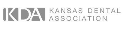 The kansas dental association logo is black and white.