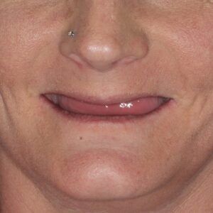 A close up of a woman 's face with her tongue out.