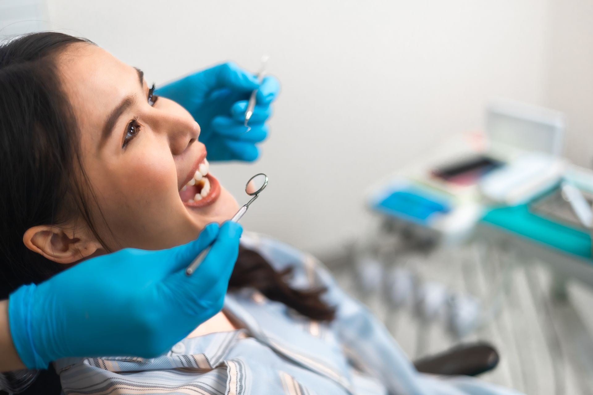 A woman having her teeth examined at a dentist check-up. A woman having her teeth examined at a dentist check-up.