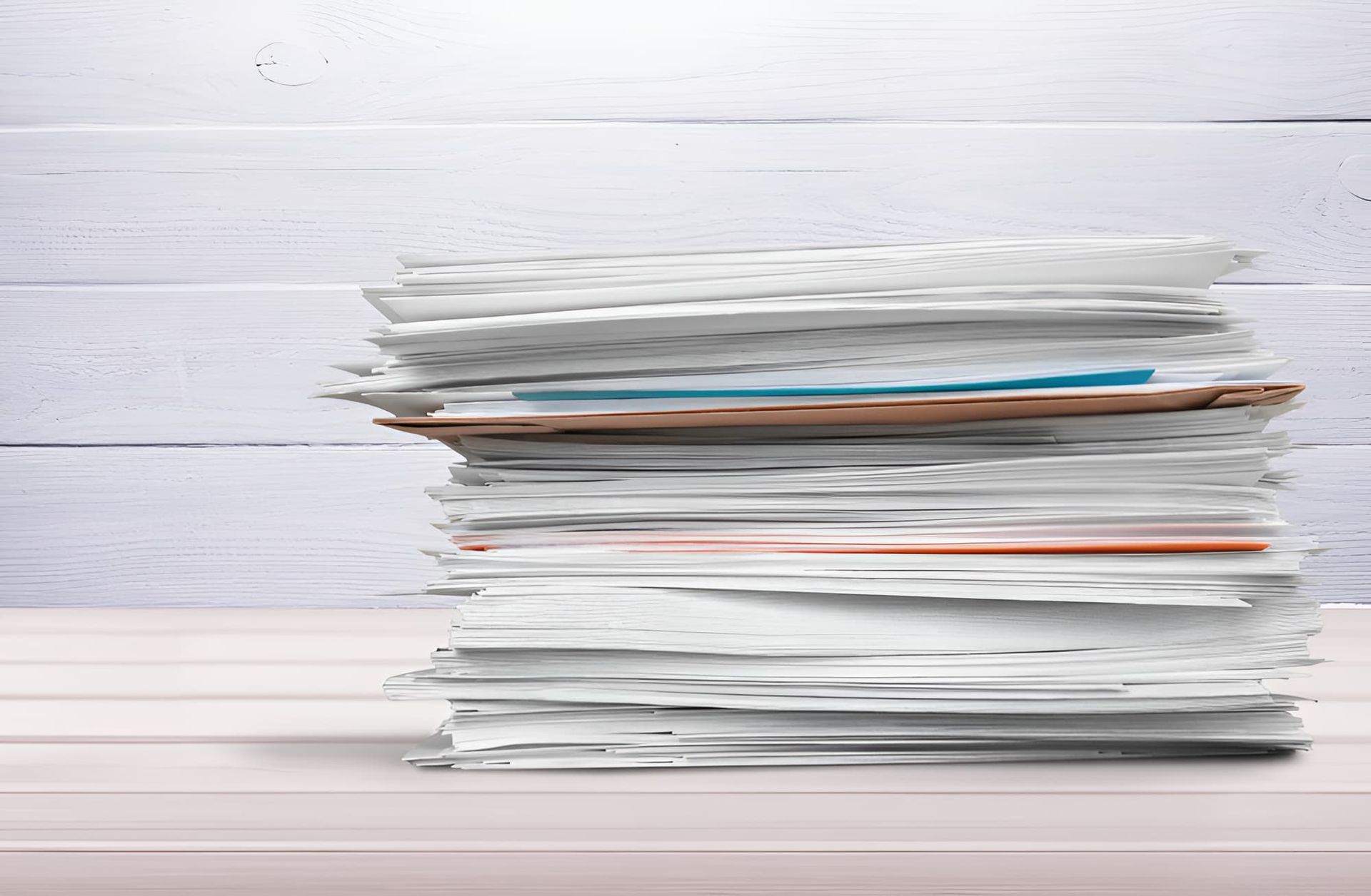 A Stack Of Papers Is Sitting On A Wooden Table — North Queensland Recycling Agents In Bungalow, QLD