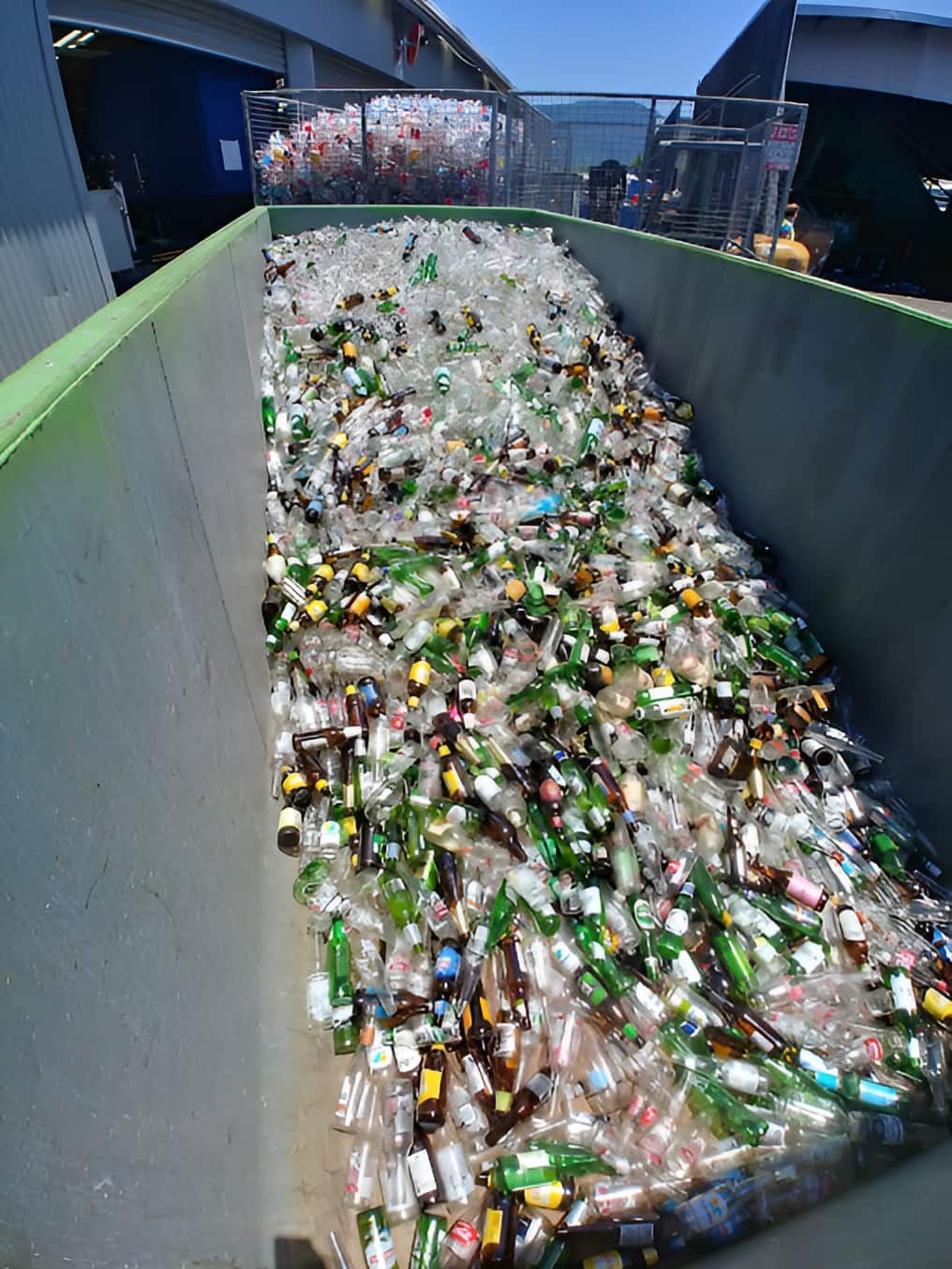 A Large Bin Filled With Lots Of Empty Glass Bottles — North Queensland Recycling Agents In Bungalow, QLD