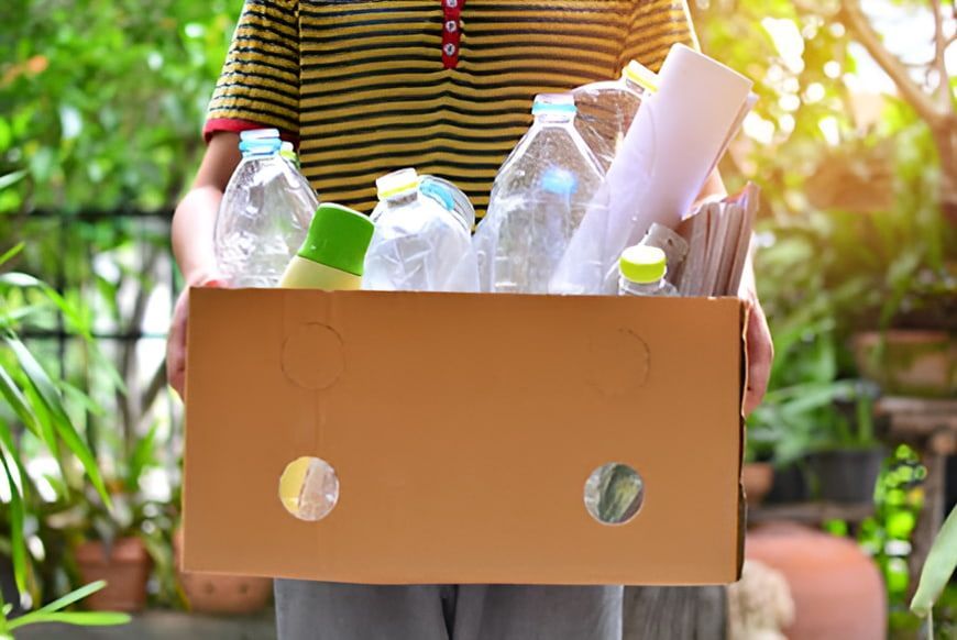 A Cardboard Box Filled With Plastic Bottles And Paper — North Queensland Recycling Agents In Bungalow, QLD