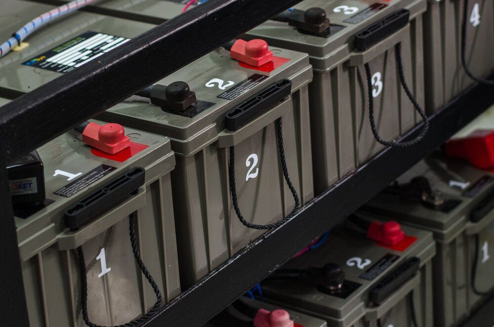 A Bunch Of Batteries Are Stacked On Top Of Each Other On A Table — North Queensland Recycling Agents In Bungalow, QLD