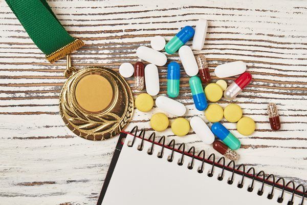 Gold medal and pills and a notebook
