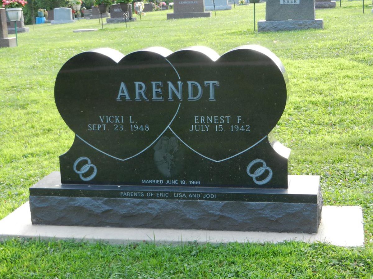 A black heart shaped gravestone with the name arendt on it