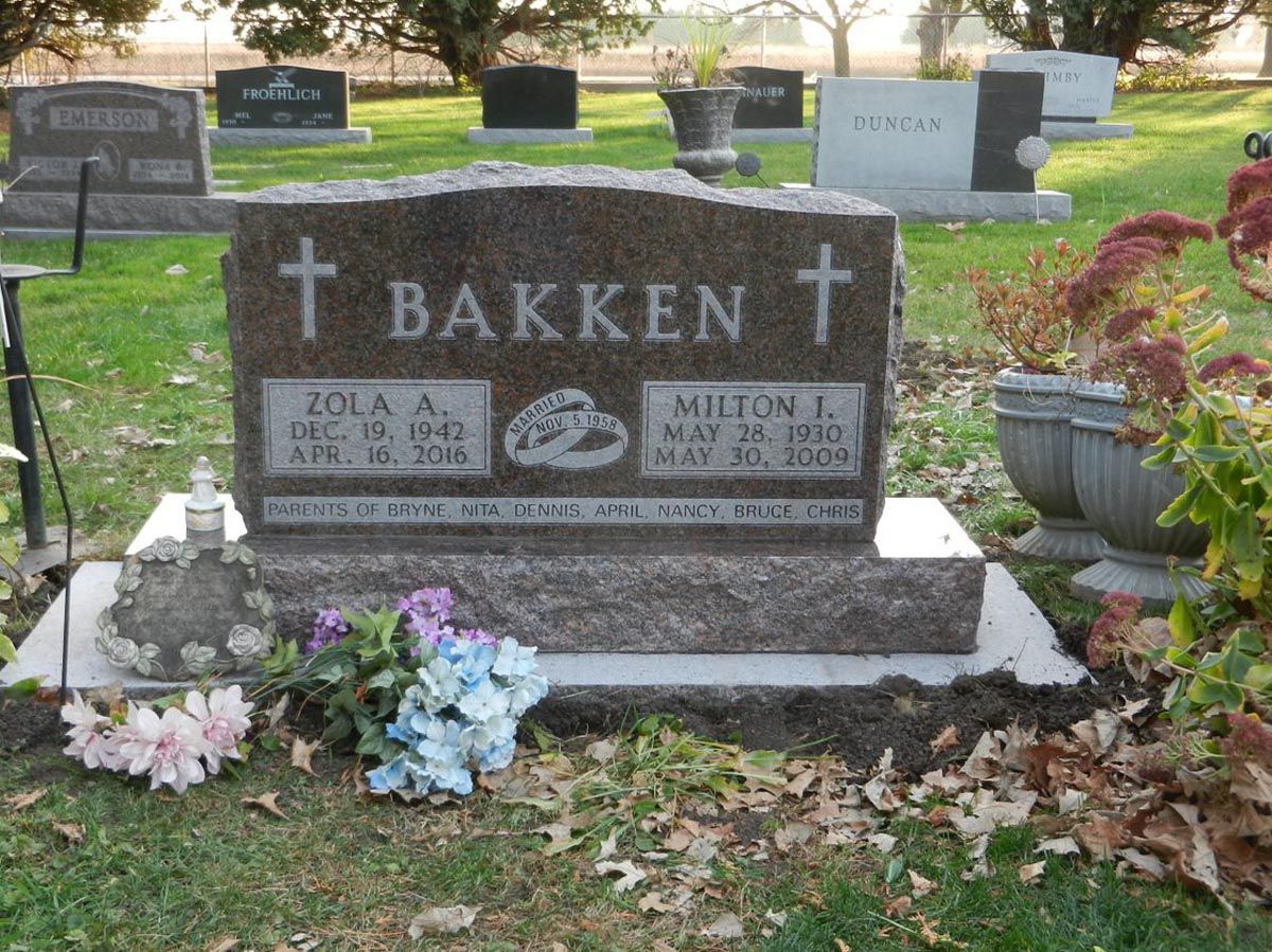 A grave in a cemetery with the name bakken on it