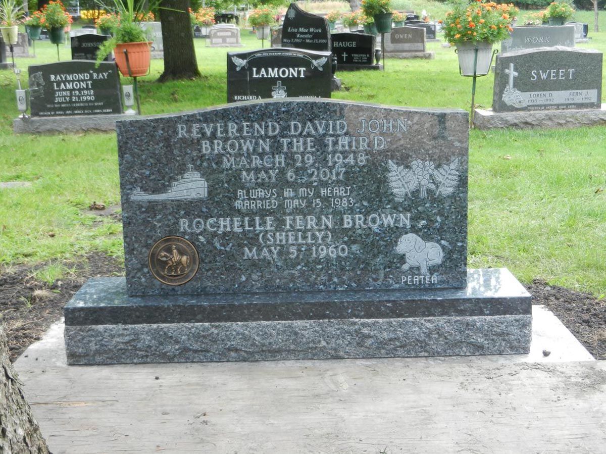 A grave in a cemetery with the name riverend david brown on it