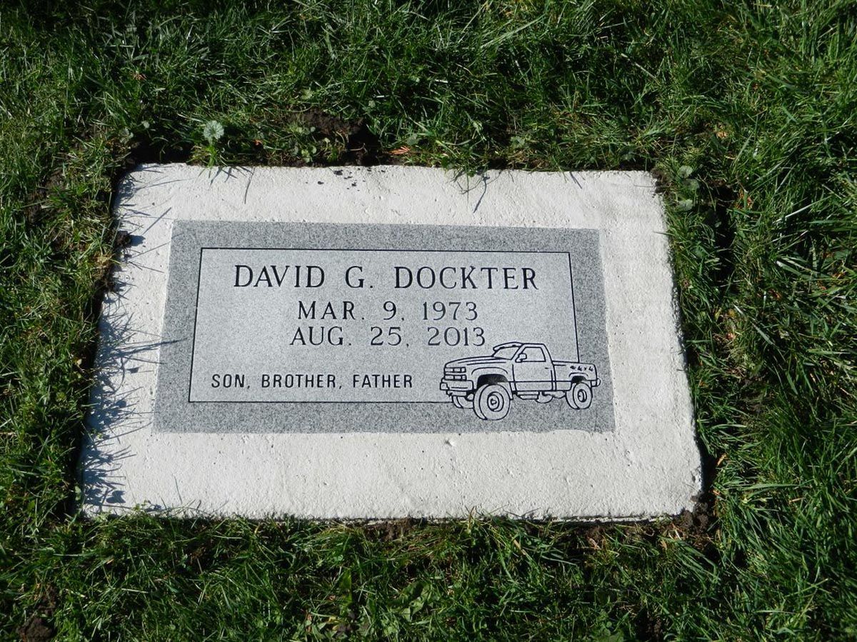 A gravestone for david g. dookirr is in the grass