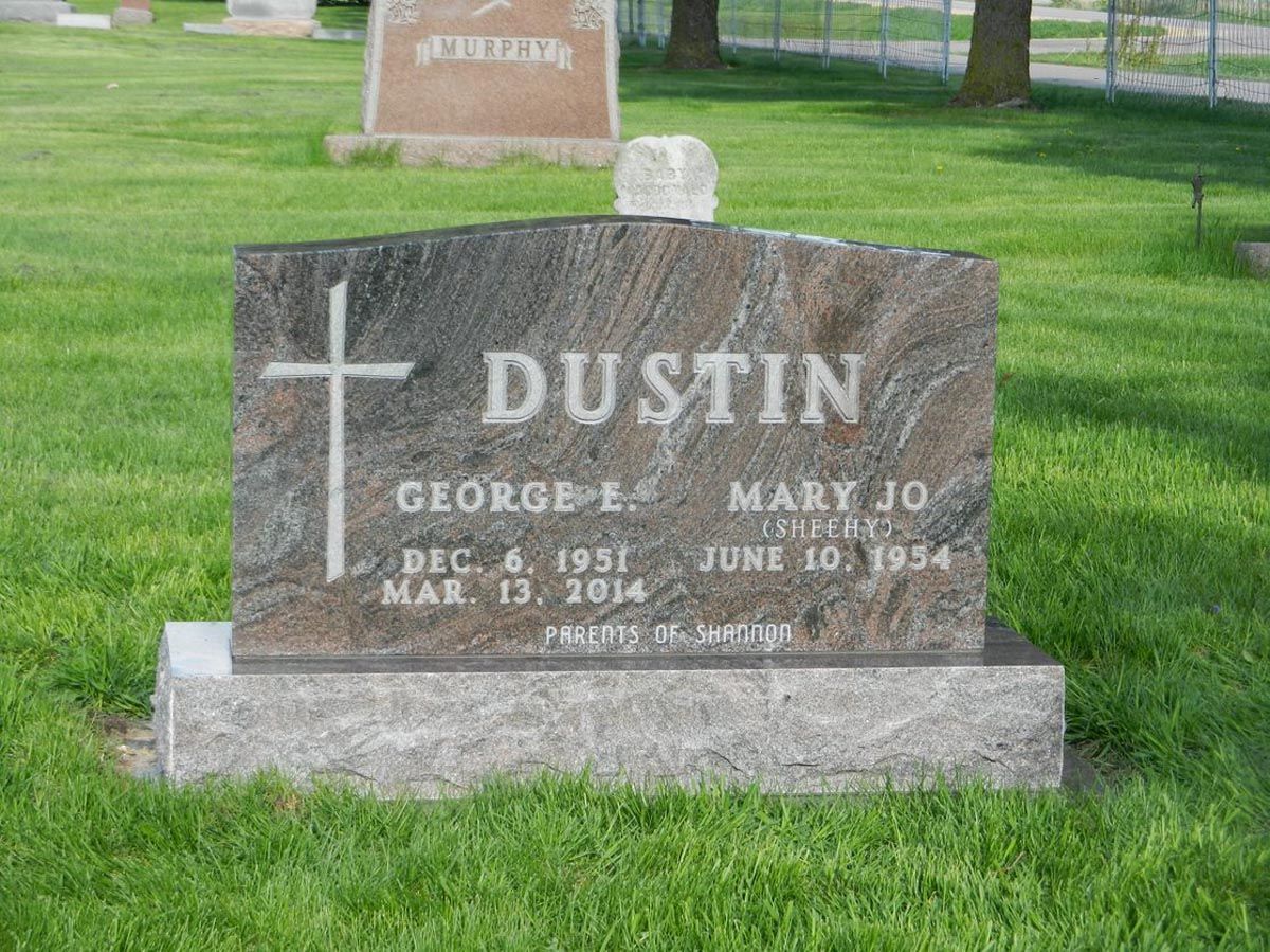 A gravestone in a cemetery with the name dustin on it