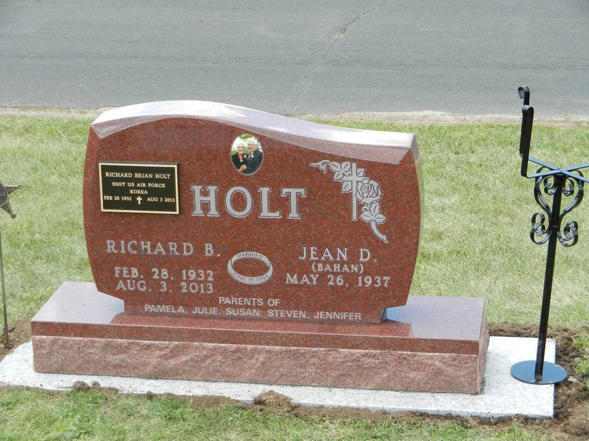 A red gravestone with the name holt on it