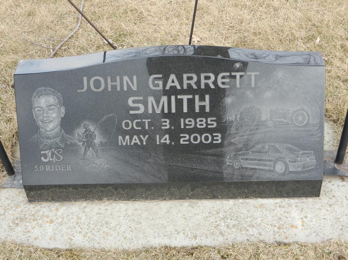 A gravestone for john garrett smith who died on may 14 2003