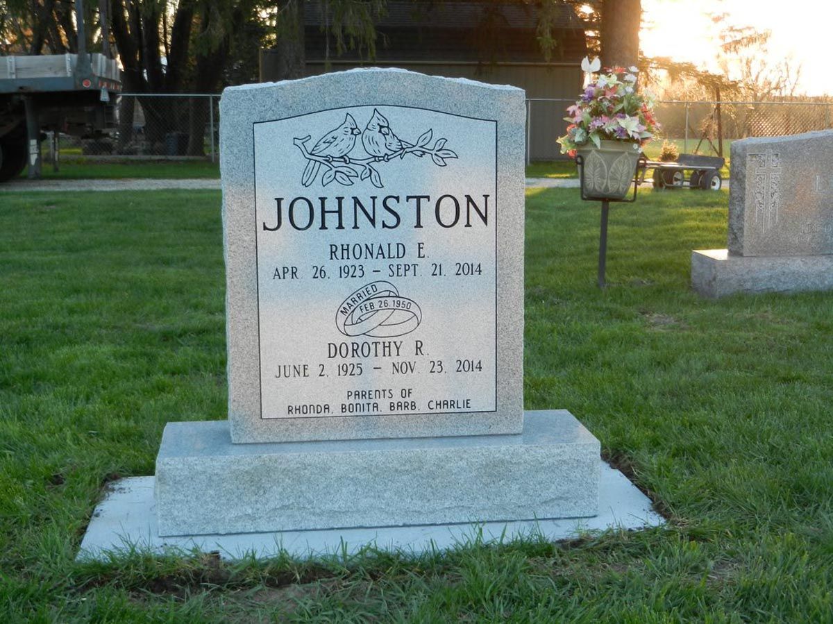 A gravestone in a cemetery with the name johnston on it