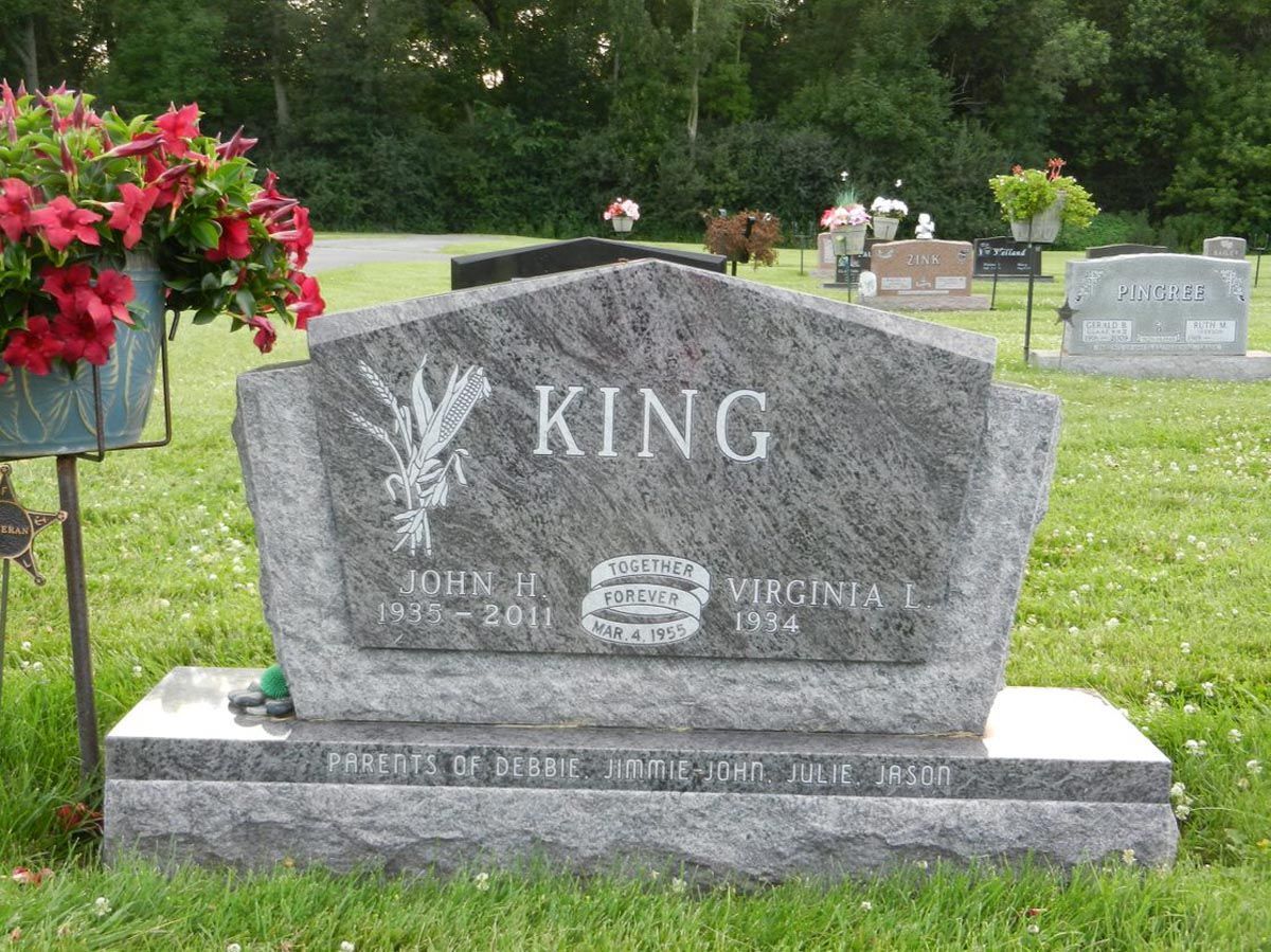 A gravestone in a cemetery with the name king on it