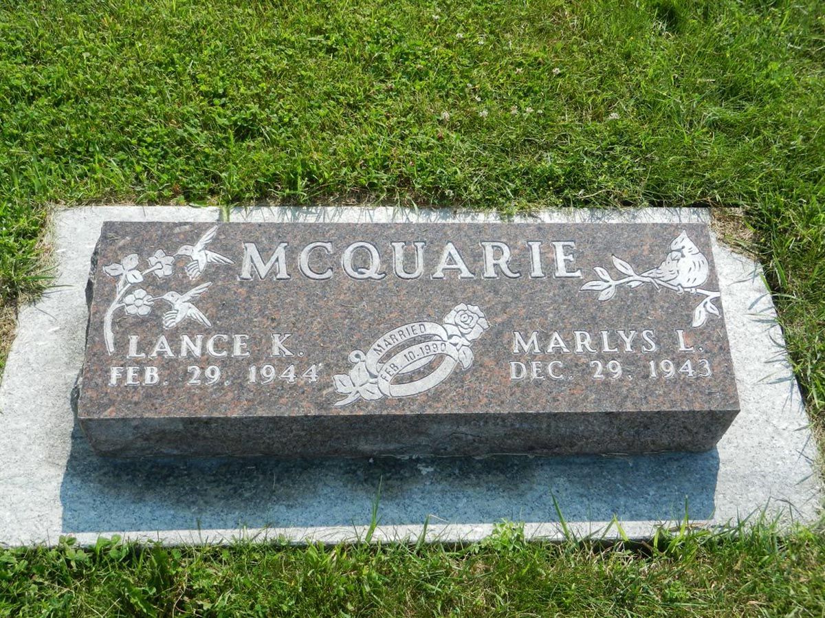 A gravestone in a cemetery with the name mcquarie on it