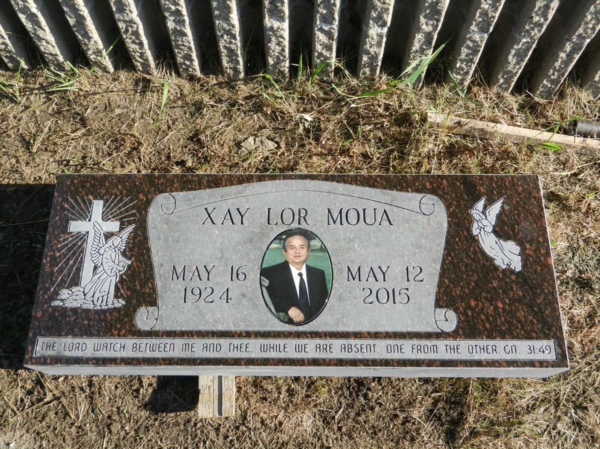 A grave with a picture of a man on it