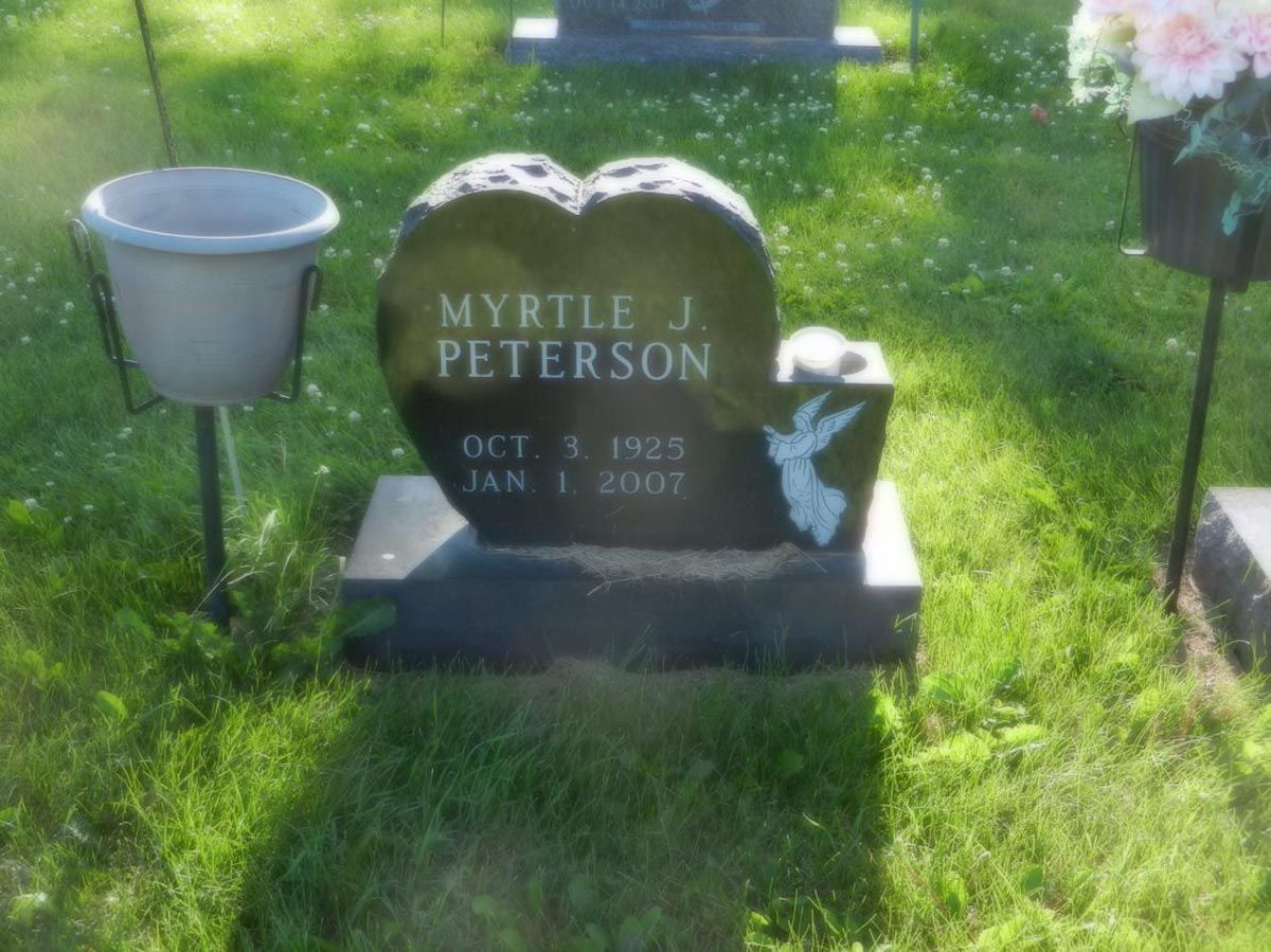 A gravestone for myrtle j peterson in a cemetery