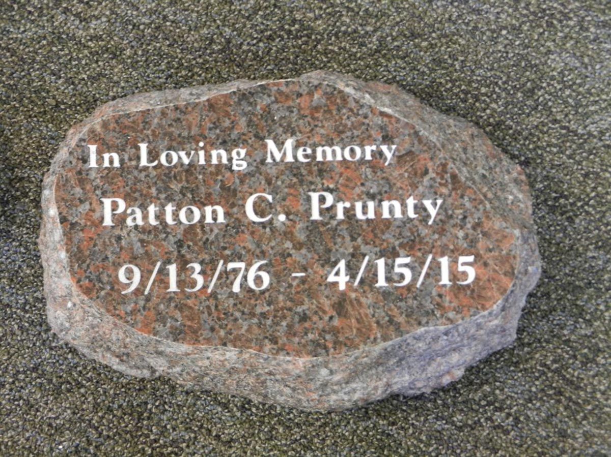 A stone with the words in loving memory patton c. prunty written on it