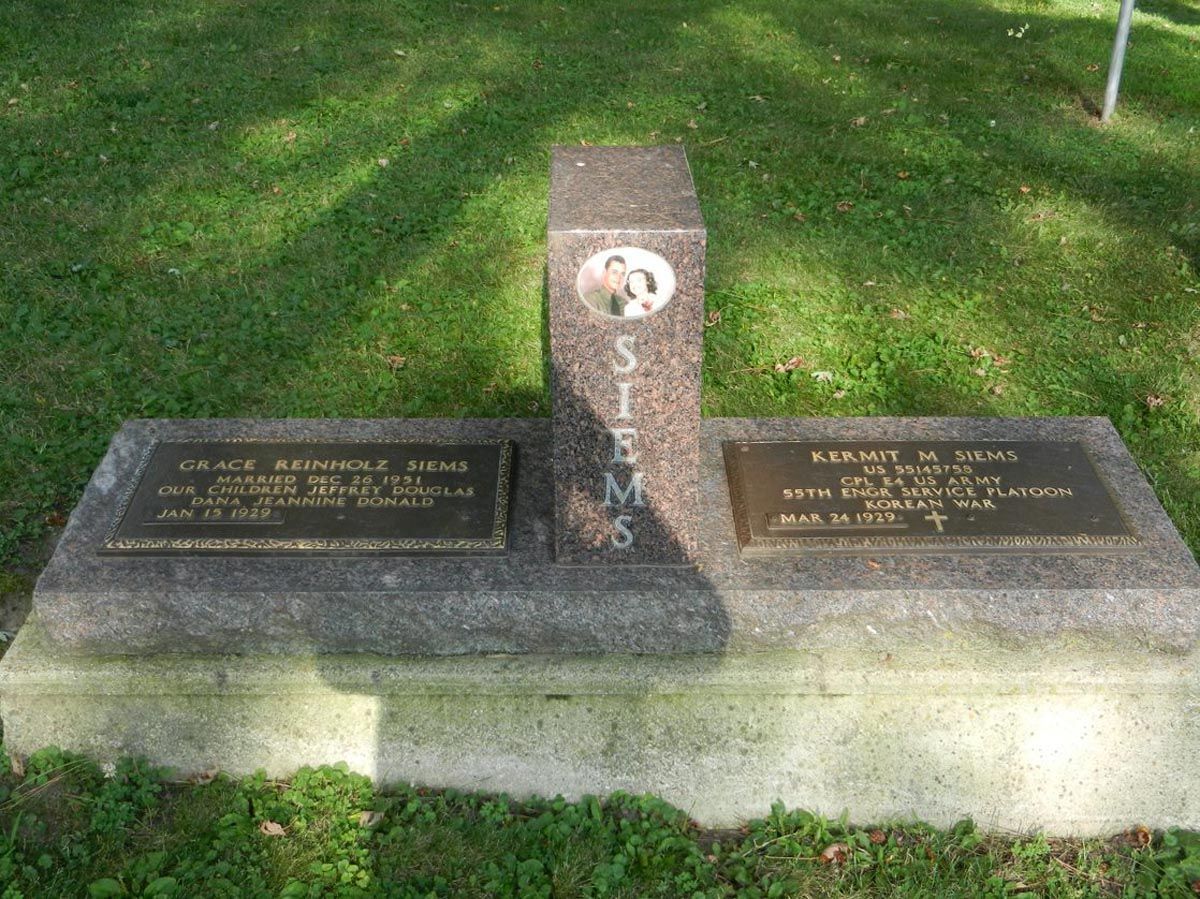A graveyard with two graves and a plaque that says 'stevens' on it