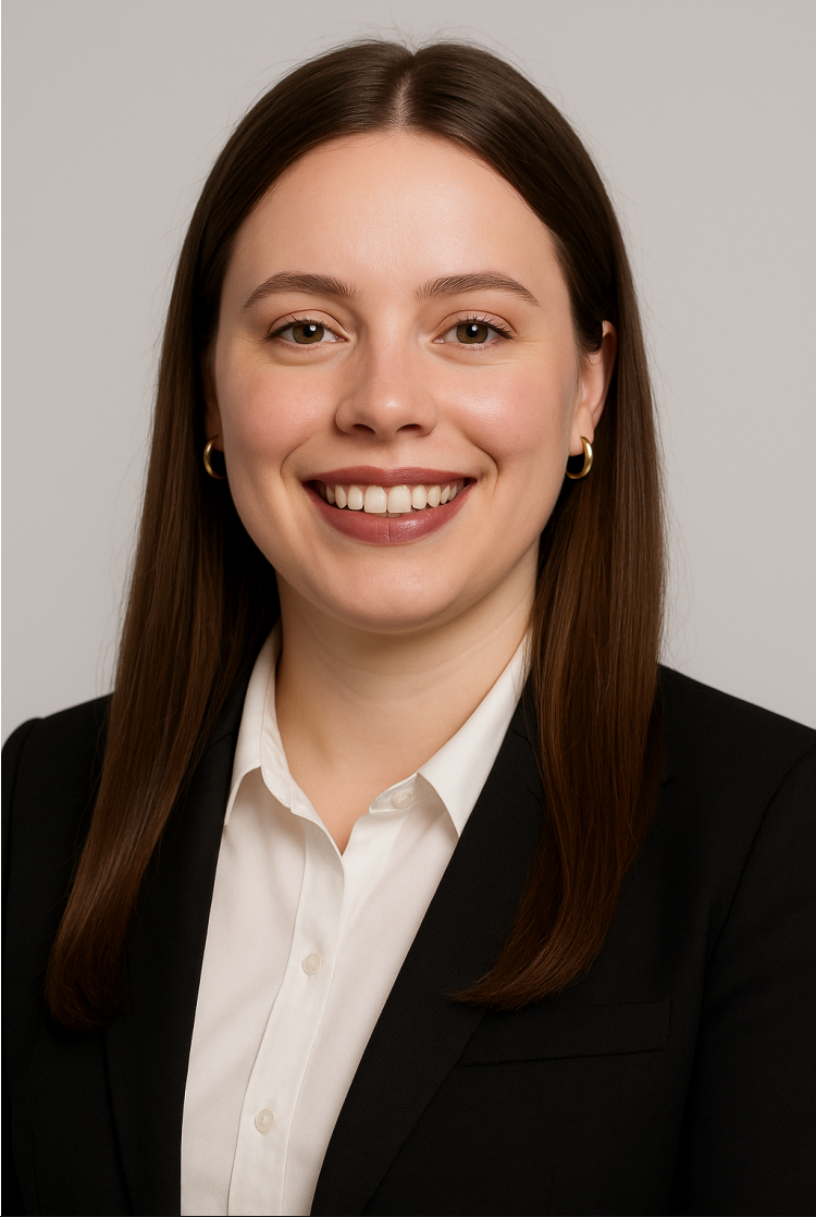 A woman in a suit and white shirt is smiling for the camera.