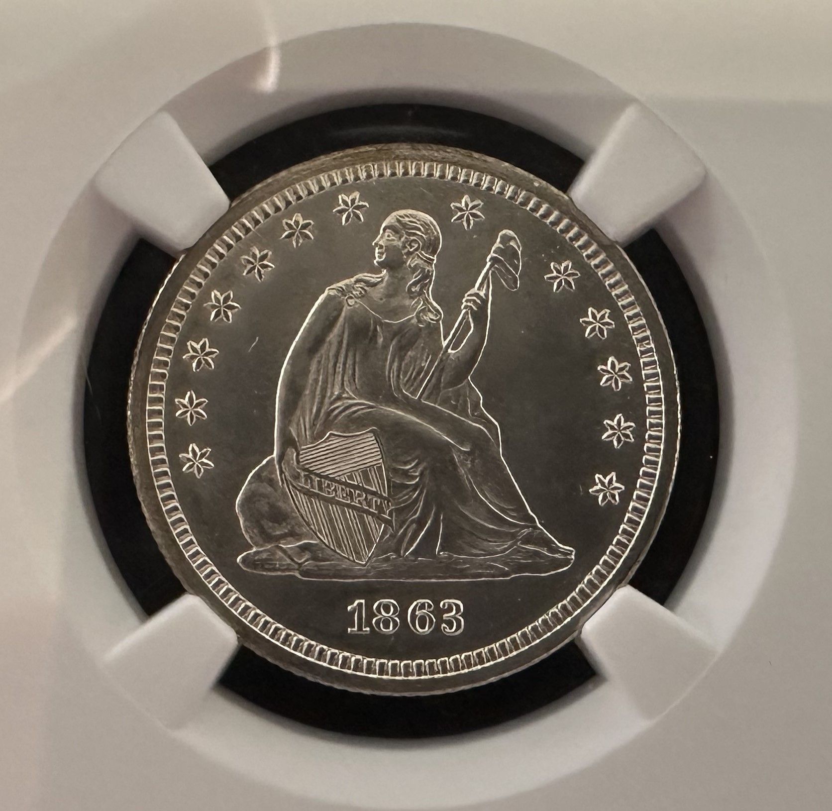 A stack of coins with a dollar coin in the foreground