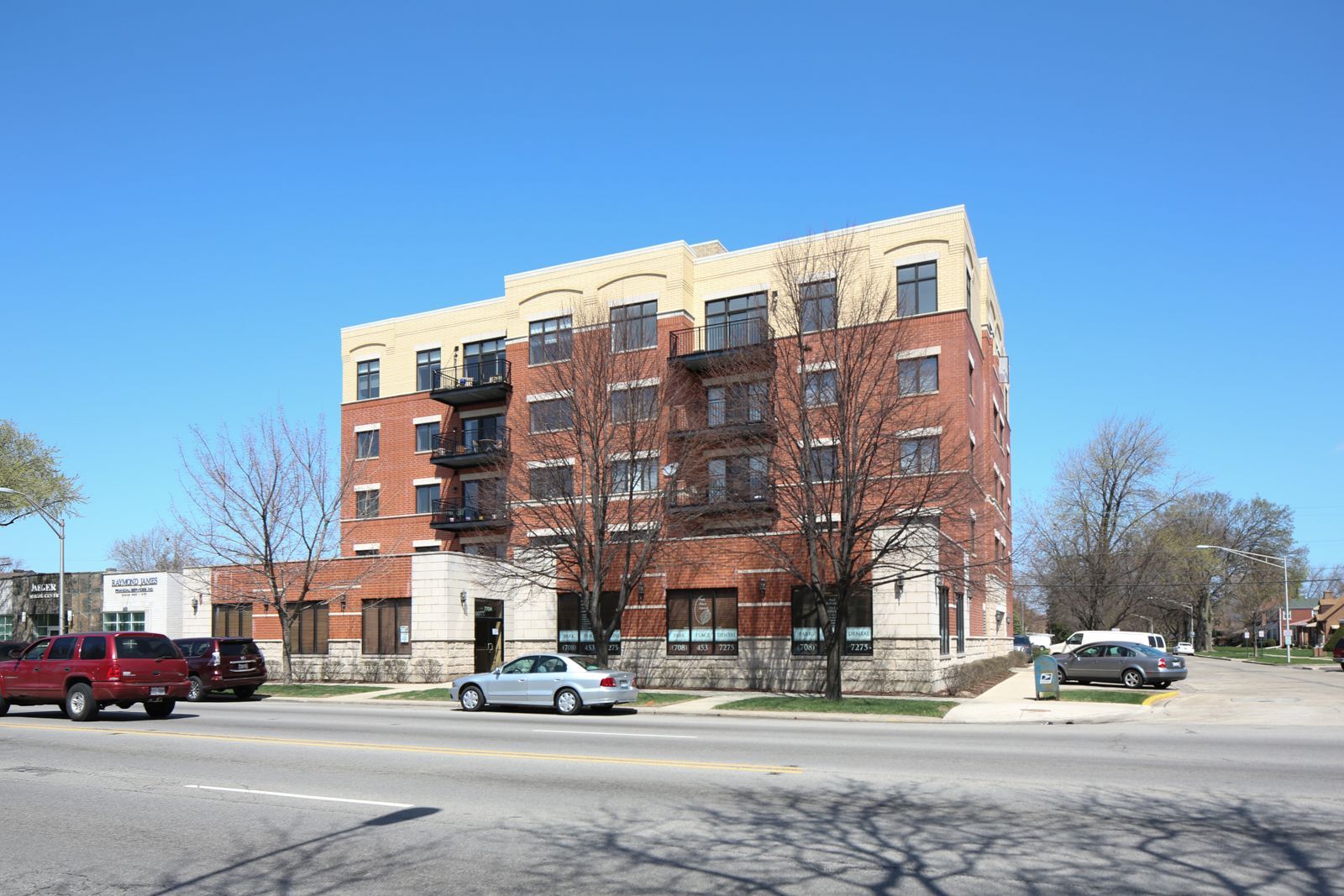 A large brick building with cars parked in front of it