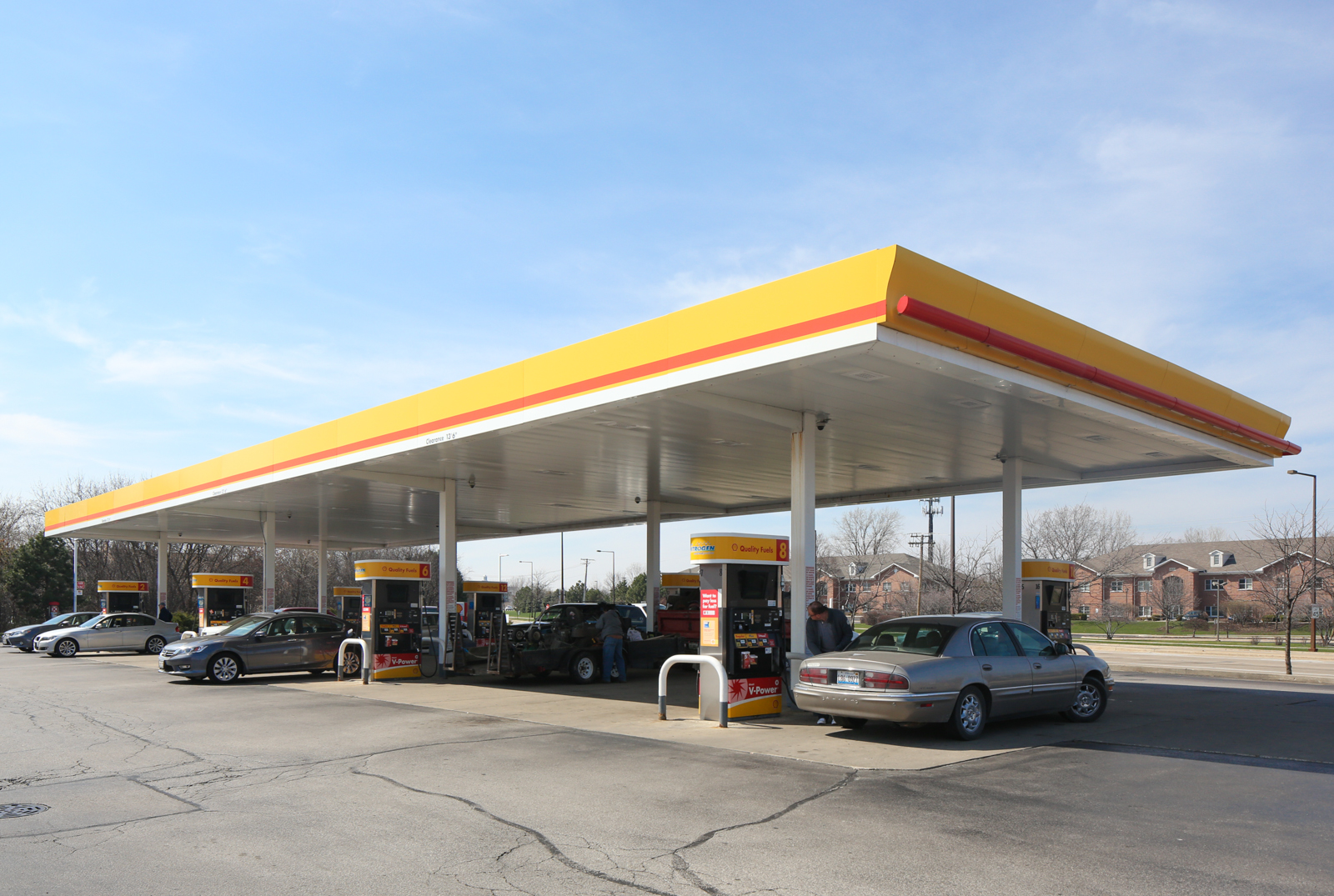 A gas station with cars parked in front of it