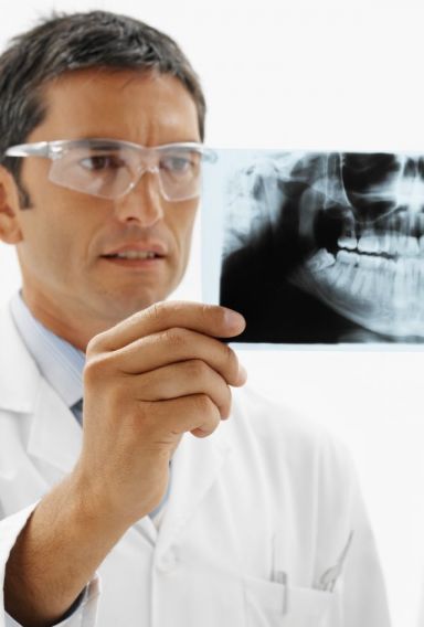 Dentist examining an x-ray