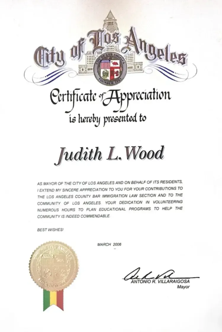 A certificate of appreciation from the city of los angeles is being presented to judith l. wood.