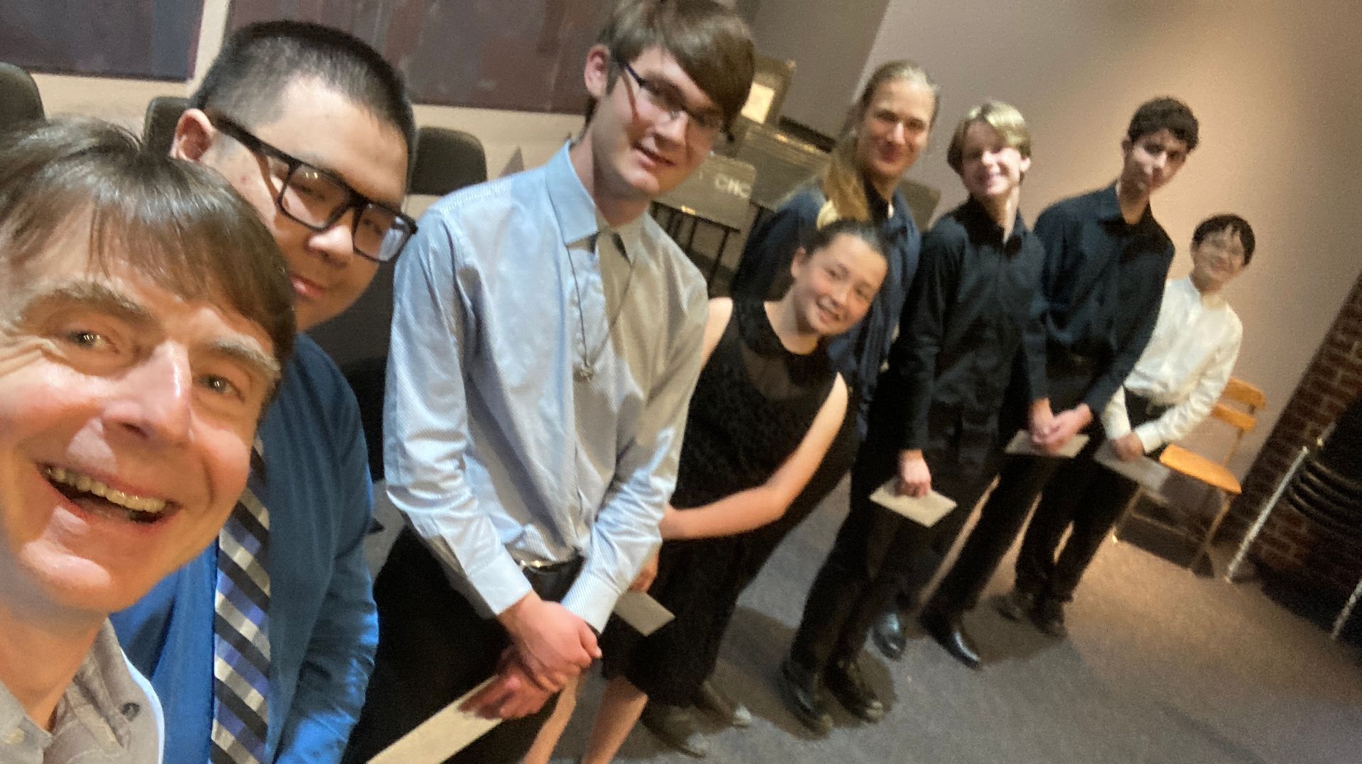 Honored students in a group selfie after receiving their awards presentation.