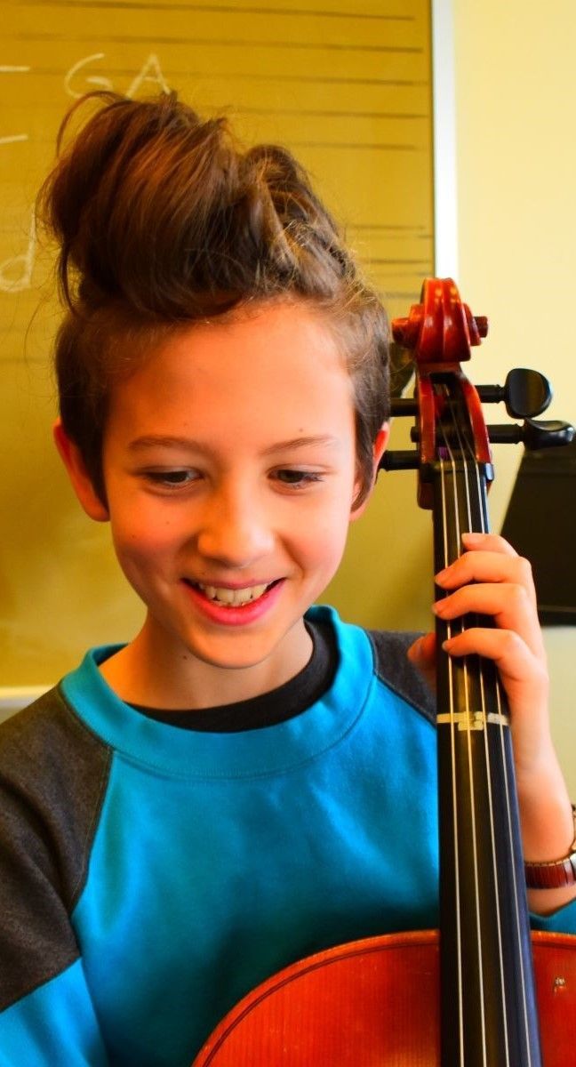 smiling child with cello