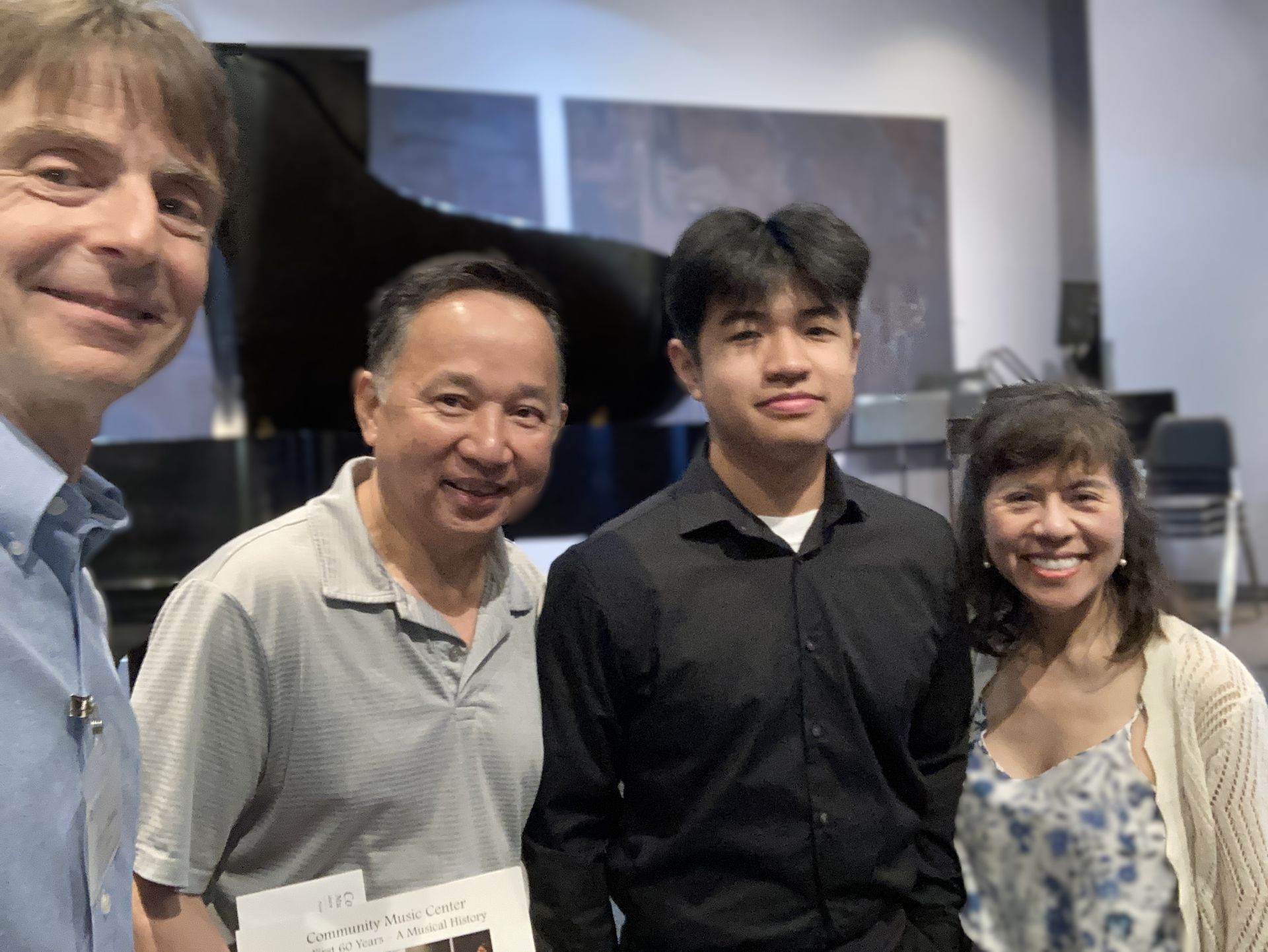 Student with parents and CMC Director in front of piano