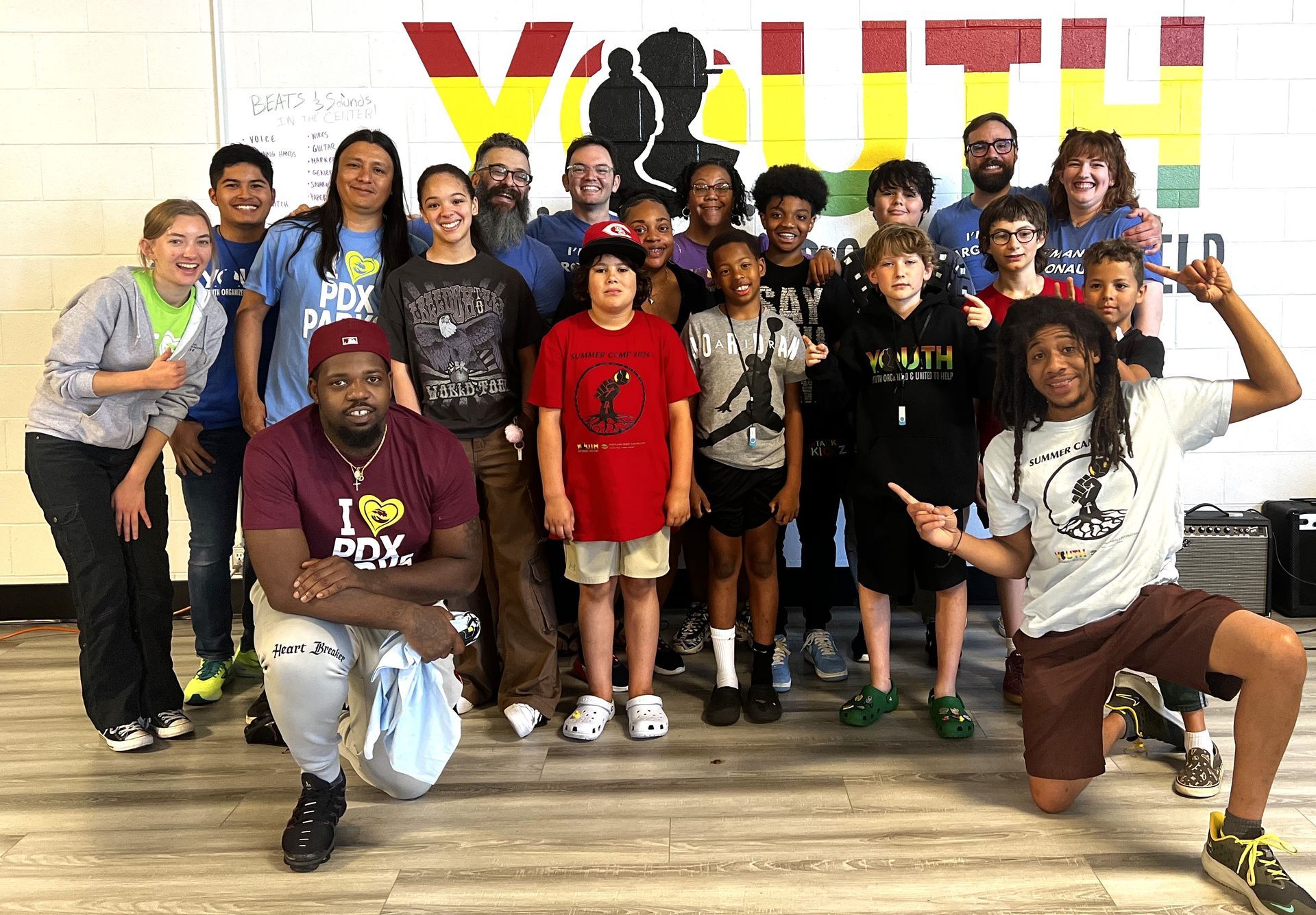 Group photo of students, teachers and staff at the YOUth Center. 