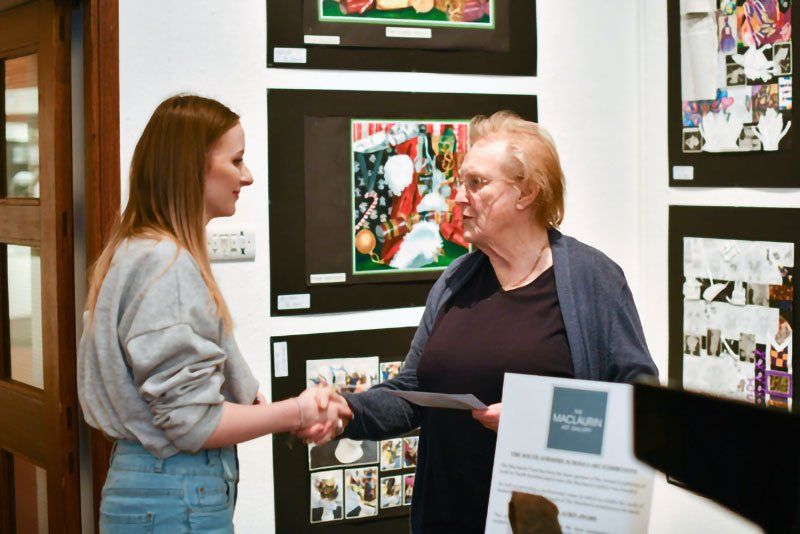 Mhairi receiving her prize from Helen Turner