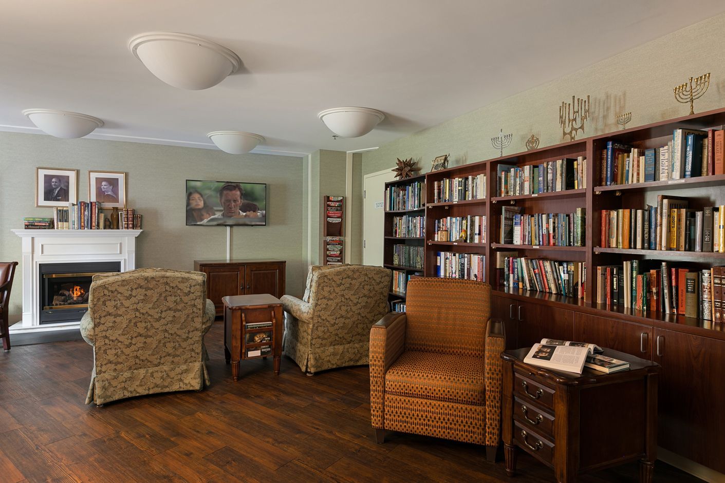 A living room filled with furniture and bookshelves.