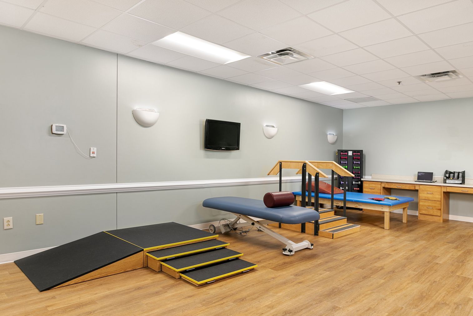 A large room with a lot of exercise equipment in it.