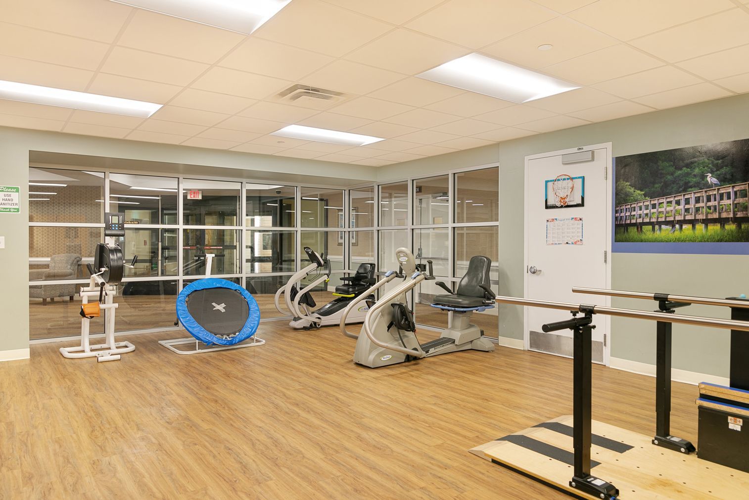 A gym with a lot of exercise equipment and a trampoline.