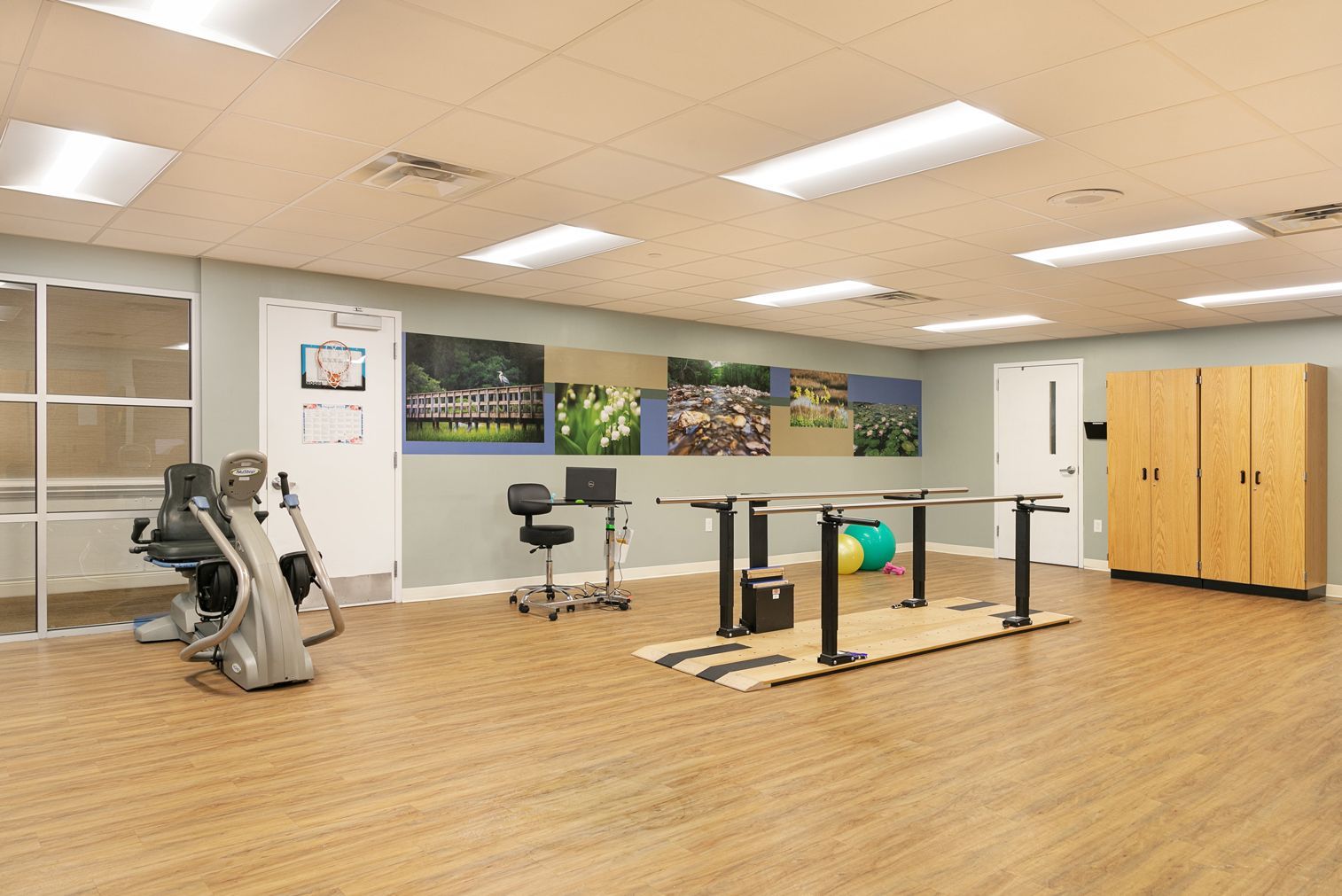A large room with a lot of exercise equipment in it.