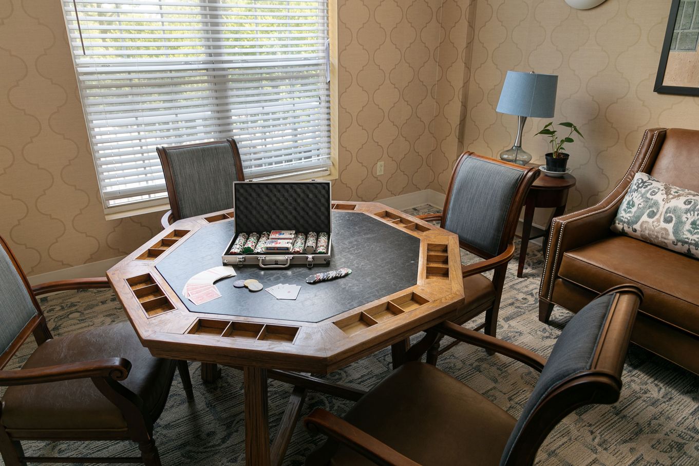 A room with a table and chairs and a briefcase on top of it.