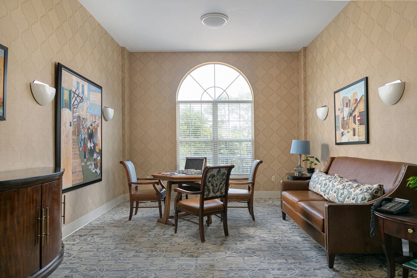 A living room with a couch , table and chairs