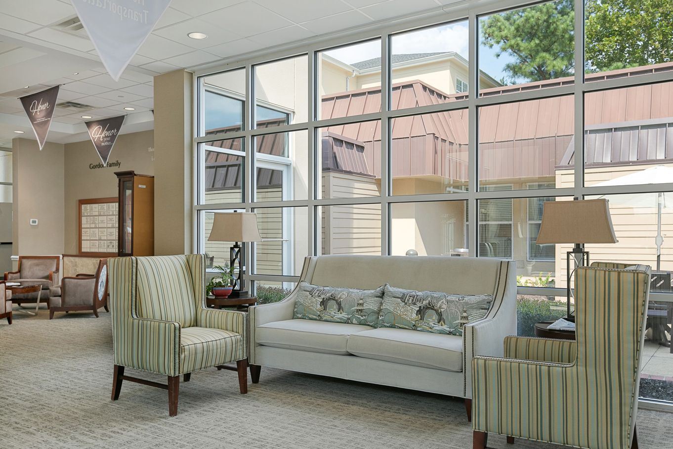A living room with a couch , chairs and lamps