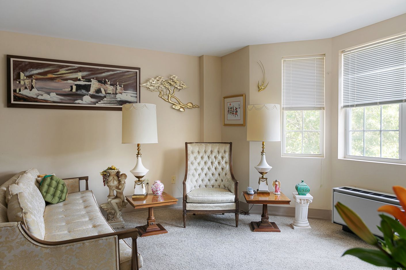 A living room with a couch a chair and a table